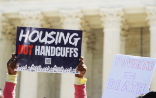 Housing Not Handcuffs rally sign